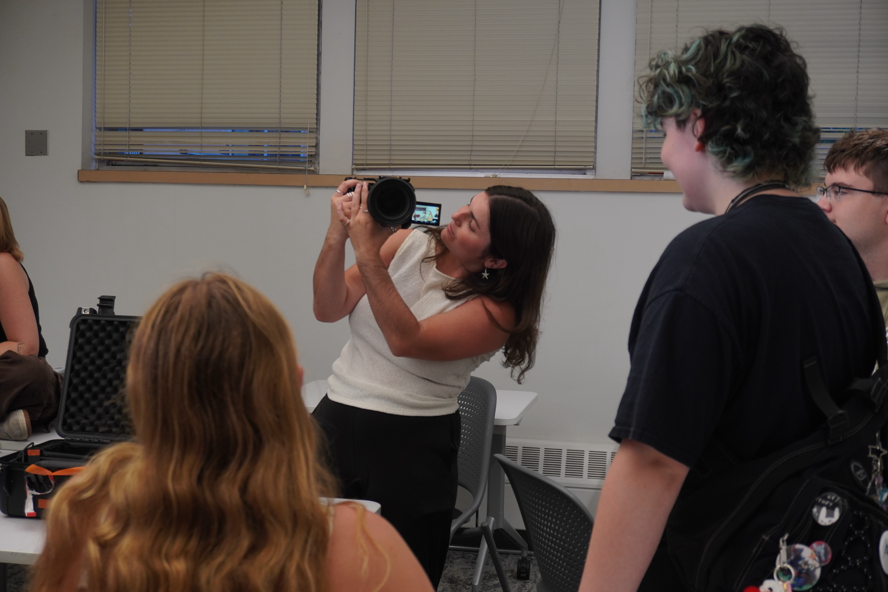 Madeline Engle teaching a camera basics workshop.